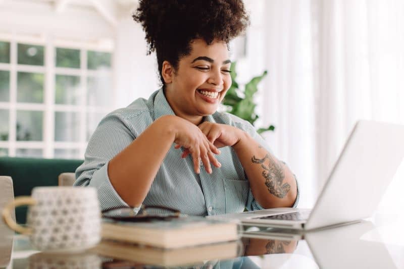 Businesswoman teleconferencing on laptop while working from home. Businesswoman teleconferencing on laptop while working from home.