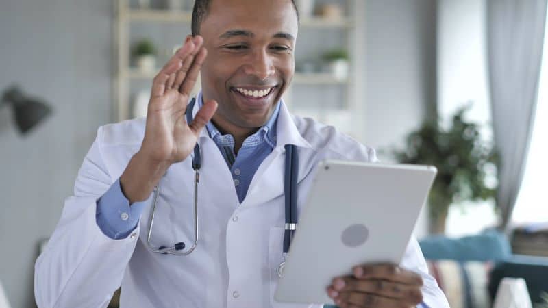 Male doctor having a discussion with a patient via video chat. Male doctor having a discussion with a patient via video chat.
