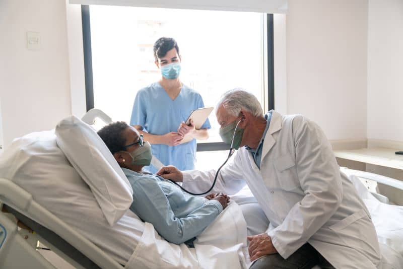 Male doctor caring for female patient. Male doctor caring for female patient.