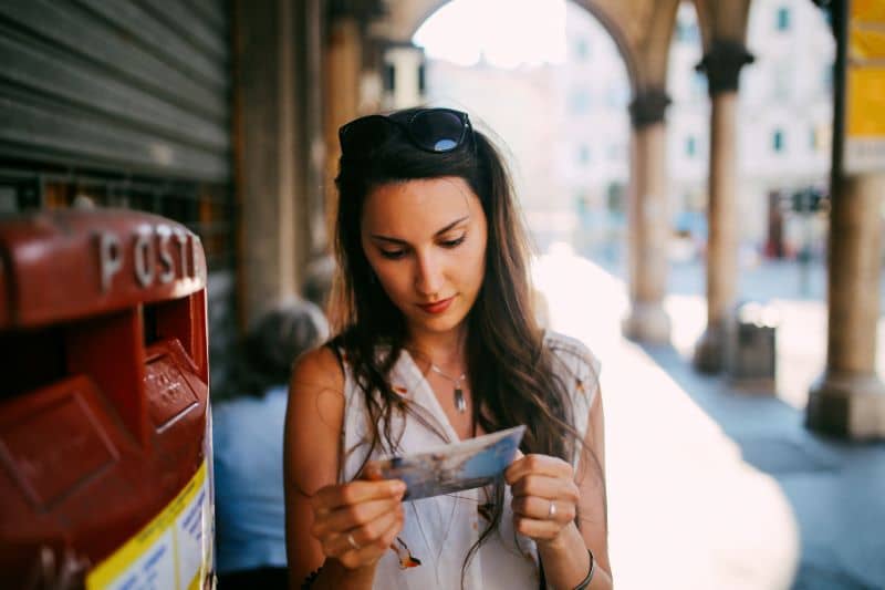 Portrait of a female traveler in Trieste, Italy writing a postcard Portrait of a female traveler in Trieste, Italy writing a postcard