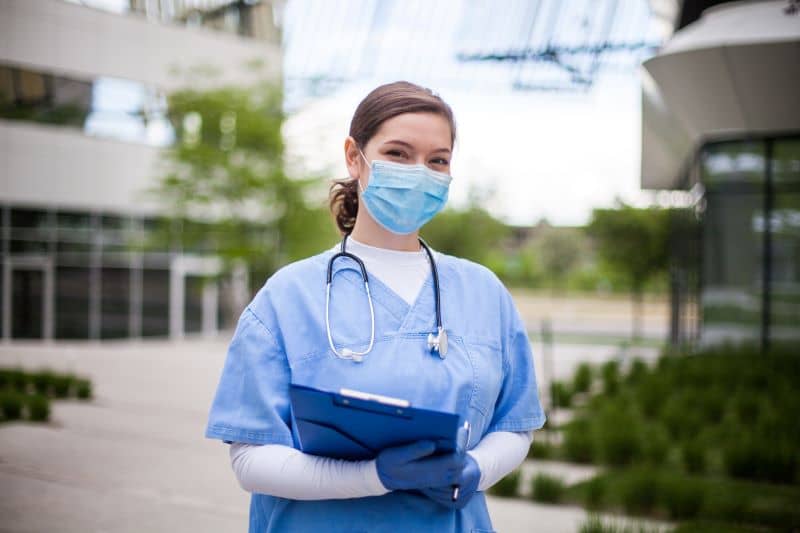 Nurse in front of hospital Nurse in front of hospital