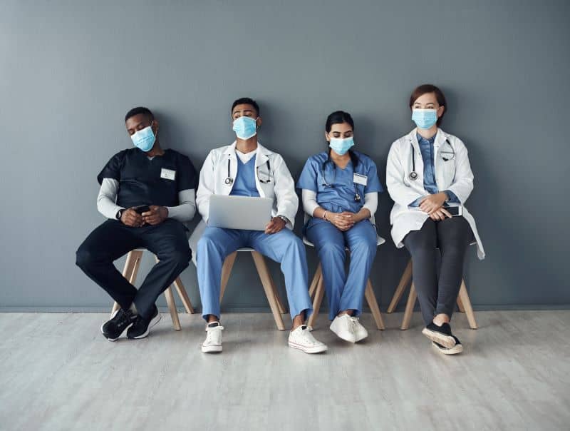 A group of overworked nurses sitting around. A group of overworked nurses sitting around.
