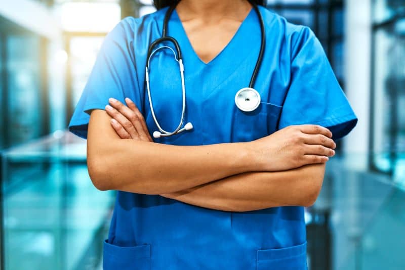 Shot of an unrecognisable nurse standing in a hospital Shot of an unrecognisable nurse standing in a hospital