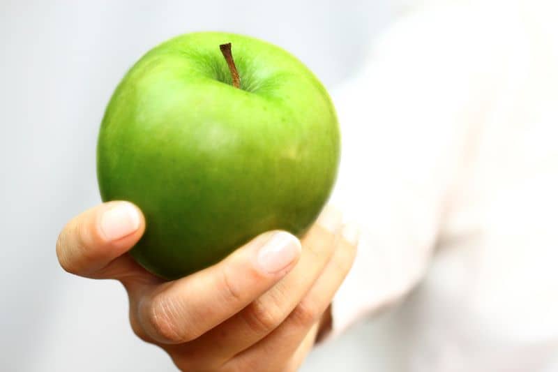 Green apple in hand Green apple in hand