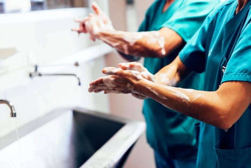 Couple of Surgeons Washing Hands Before Operating. Couple of Surgeons Washing Hands Before Operating.