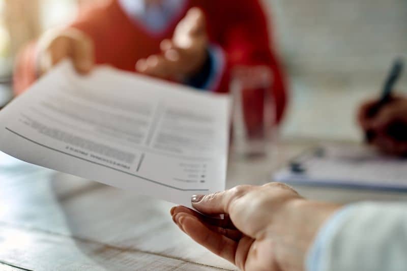 Close-up of a candidate giving his CV while applying for a job. Close-up of a candidate giving his CV while applying for a job.