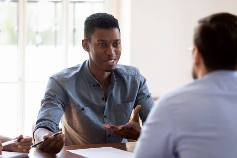 Two business professionals having a discussion. Two business professionals having a discussion.