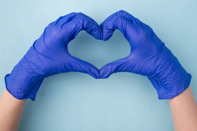 Close up photo of hands gesturing heart isolated over blue color background. Close up photo of hands gesturing heart isolated over blue color background.