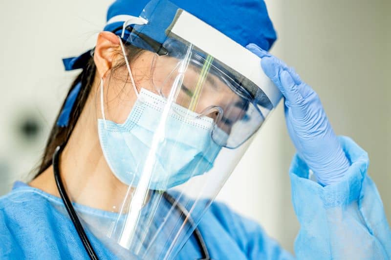 An overwhelmed female nurse An overwhelmed female nurse