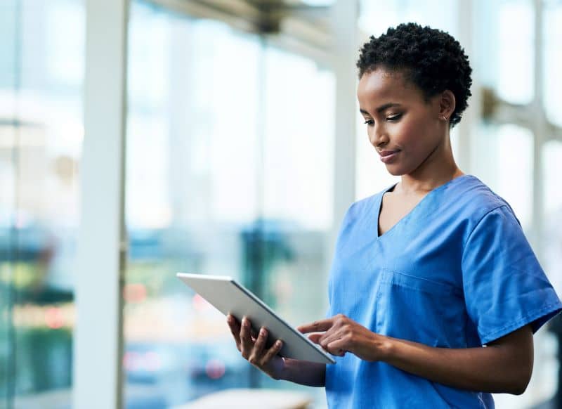 Shot of a young medical practitioner using a digital tablet in a hospital Shot of a young medical practitioner using a digital tablet in a hospital